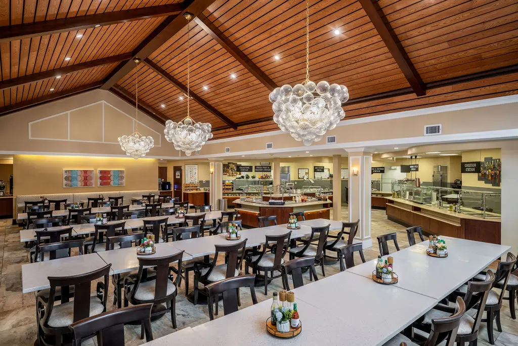 Dining hall with a vaulted wood ceiling and long tables